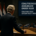 Geert Wilders stands at a podim expressing opposition to the governm's asylum policy throwing the government into crisis
