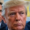 : Image of Trump caught between two National conservative figures, with a map of Iran in the background, symbolizing the MAGA coalition split over Iran policy.
