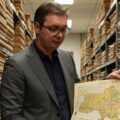 The Serbian President looking at a map of Ukraine deciding what do do about Russian influence in the coup