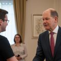 A German conservative leader, shaking hands with an AFD supporter, symbolizing how the German conservatives are empowering the far right in German Germany