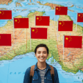 An image of a smiling Australian youth with Chinese flags planted in Australia, symbolizing China's youth exchange programs as influence operations