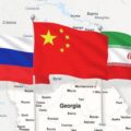 A map of Georgia with the flags of Russia, China, and Iran showing the collapse of democracy and it's opening of the country to foreign influence