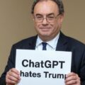 Attorney General Andrew Bailey holding a sign alleging bias by chat box against Trump