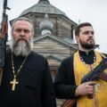 Serbian orthodox church priests with weapons in their hand, showing the use by Russia of the church for influence in the Balkans
