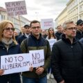 demonstrators in Poland carrying signs against the countries, illiberalism, illustrating Donald Tusk challenges to restoring demoracy