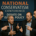 Men debating at a conference event.US conservatives split about Israel policy at the national conservative conference