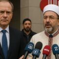 AI picture of a German government official and Diyanet head Ali Erbaş standing together at a formal event, visually representing the complex diplomatic and ideological tensions between German authorities and Turkey’s religious leadership.