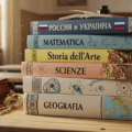 Italian school books with a Russian book on Ukraine at the top showing the Russian influence operations in Italy