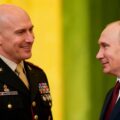 Troll farm operator John Mark Dougan shaking hands with Vladimir Putin, illustrating his importance to Russian influence operations