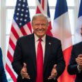 Meeting with flags in background illustrating the growth of Trump style populism in France and the UK