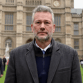 Nathan Gill standing in front of the UK houses of Parliament symbolizing his MEP recruitment operation on behalf of Russia praised by Putin